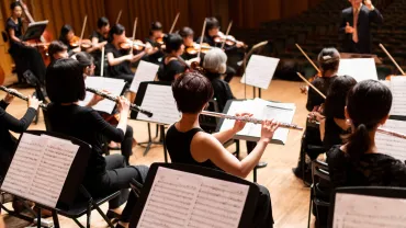 An orchestra performing on stage