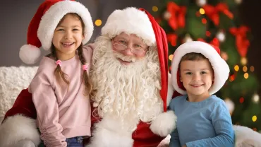 Children sitting on Santa Claus's knees