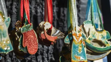 Handmade ceramic Christmas ornaments hanging at a holiday fair