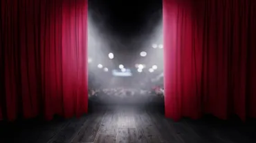 Red theater curtains opening for a show