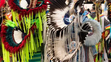 Two Native American fancy dancers waiting to dance at a powwow