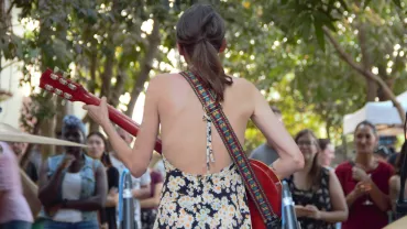 Female singer-songwriter performing live