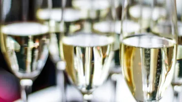 Glasses of sparkling wine served at a charity dinner