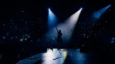 Guitarist playing in front of a crowd