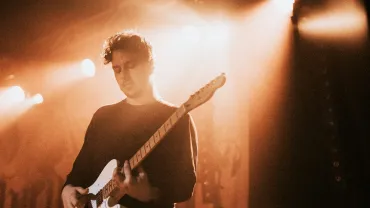 Guitarist playing electric guitar at a concert