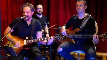 Band playing electric guitar and bass on stage