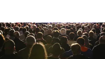 Audience seated in front of a film screen