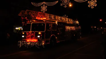 Lighted float in a Christmas parade at night