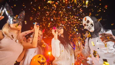 People in costumes dancing at a Halloween party