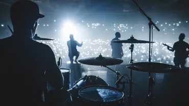 Silhouette of a band performing on a concert stage