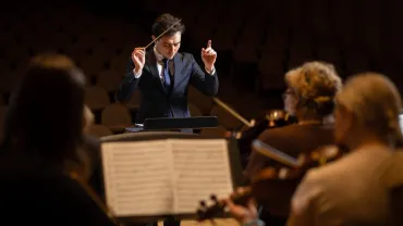 Conductor leading a symphony orchestra