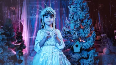 Child in a snow queen crown and costume