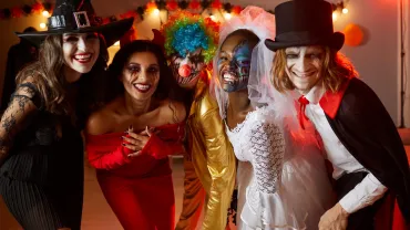 Adult friends in costumes at a Halloween party