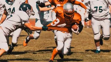 American football players fighting for the ball