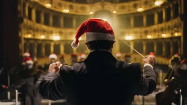 Conductor leading a symphony orchestra from behind