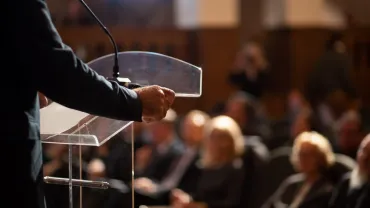 Man giving a lecture in front of an audience