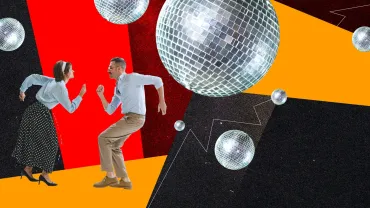 Couple in retro clothes dancing under colorful disco lights