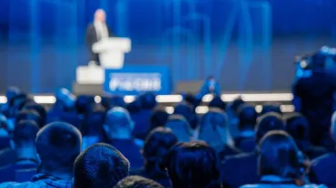 Audience listening to a speaker at a lecture