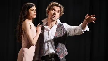 Actors performing on stage during a rehearsal