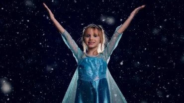 Girl in a blue snow princess costume