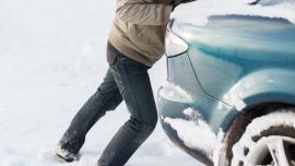 Pushing car stuck in snow