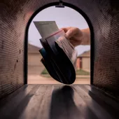 Mail being delivered to a mailbox