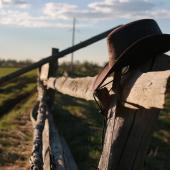 Cowboy hat on fence