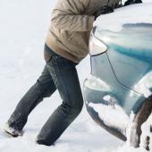 Pushing car stuck in snow